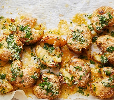 Cheesy smashed Jersey Royals with garlic butter 