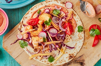 Beer-battered prawn tacos with chipotle mayo and mango slaw