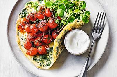 Herb omelette with harissa-roasted tomatoes