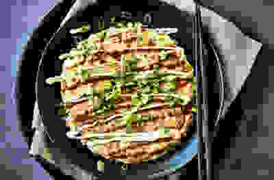 https://waitrose-prod.scene7.com/is/image/waitroseprod/Jun-Tanakas-seafood-okonomiyaki?uuid=807ec1ac-910a-4aa9-8aeb-499536f781b5&$Waitrose-Default-Image-Preset$