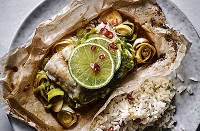Cooking  sh in parchment keeps the nutrients locked in and avoids using too much oil. Fragrant Thai herbs plus lime and chilli really elevate this simple dish.
