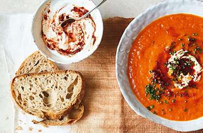 Tomato, red pepper and sweet potato soup with harissa yogurt