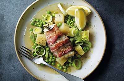 Bacon-wrapped cod with peas, leeks & potatoes
