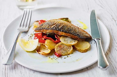 Baked sea bass with potatoes, peppers & preserved lemons