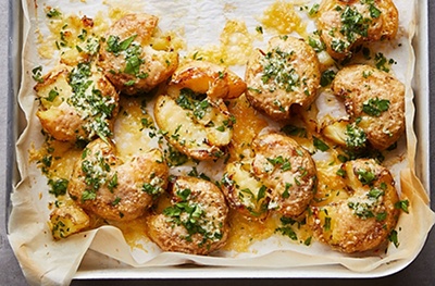 Cheesy smashed Jersey Royals with garlic butter