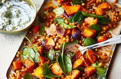 Curry-roasted vegetable & chickpea salad with raita and crispy onions