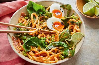 Gochujang & peanut butter udon with peas, greens & a six-minute egg