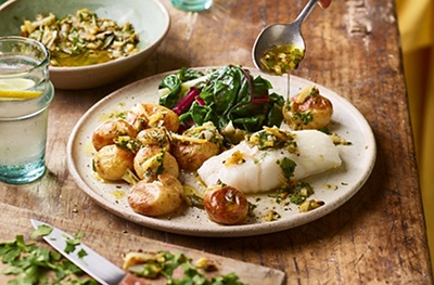 Grilled salad onion gremolata with baked cod & new potatoes