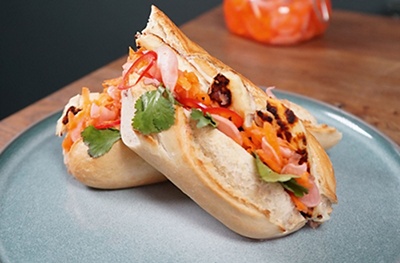 Indulgent bánh mì style baguette by John Whaite filled with halloumi, Brussels pâté and homemade pickled veg.