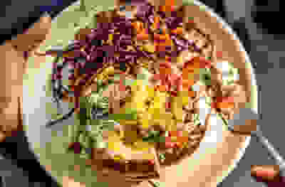 Herby cottage cheese potatoes, with crisp ham hock & slaw