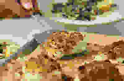 Herby crumbed fish with spinach & yogurt lentils