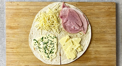 Unfolded torilla with cheese and ahm
