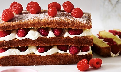 Layered lemon cake with raspberries and cream