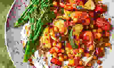 Rose harissa-roasted veg & chickpeas with Tenderstem and tahini vegan yogurt