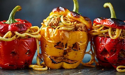 Jack-o’-lantern stuffed peppers with linguine and sausage ragù