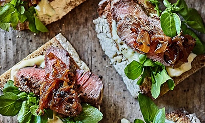 Open steak sandwiches with dark fried onions and bearnaise mayo