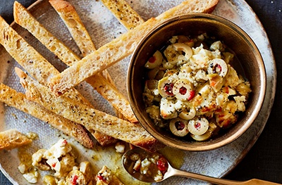 Baked feta dip with olives, truffle and artichoke