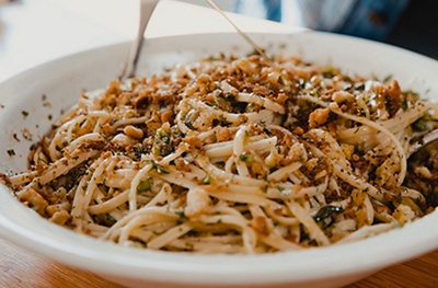 A dish of linguine with green olives and homemade breadcrumbs