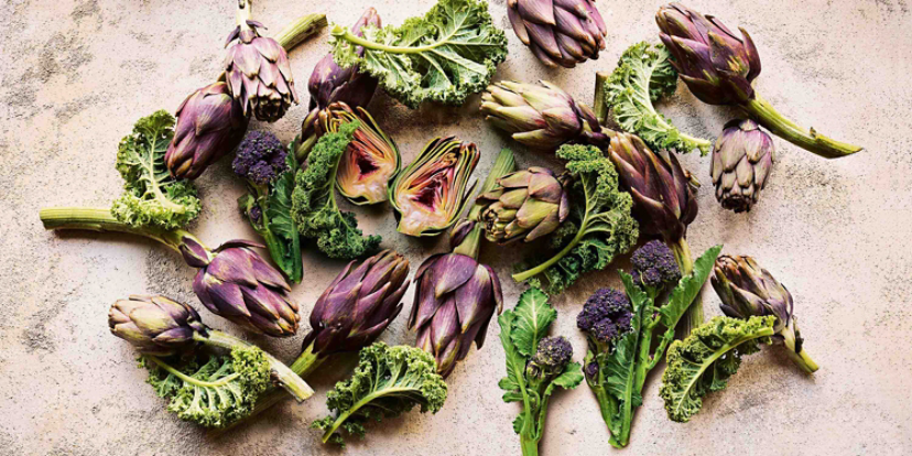 A selection of artichokes, purple sprouting brocolli and kale