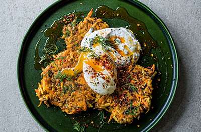Root veg & lentil fritters with poached eggs, chilli butter & garlic yogurt