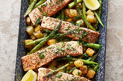 Seasonal and so easy, this recipe is special enough for friends to share. The lemon, zaatar and buttery juices from the potatoes mingle to dress the asparagus. Good with loch trout, or Essential hake fillets, too.
