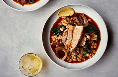 Slow-roasted pork belly with cannellini beans