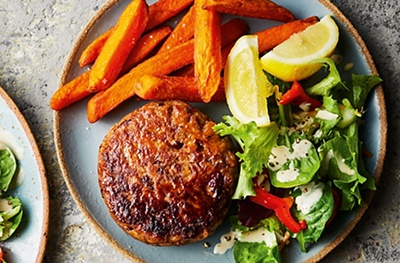 Spicy lamb & bean burgers with tahini-dressed salad and sweet potato chips