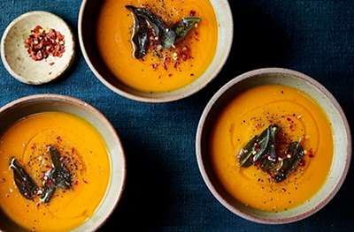 Squash and carrot soup with crispy sage leaves
