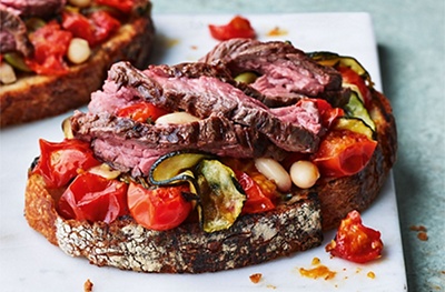 Steak on sourdough with garlicky tomatoes